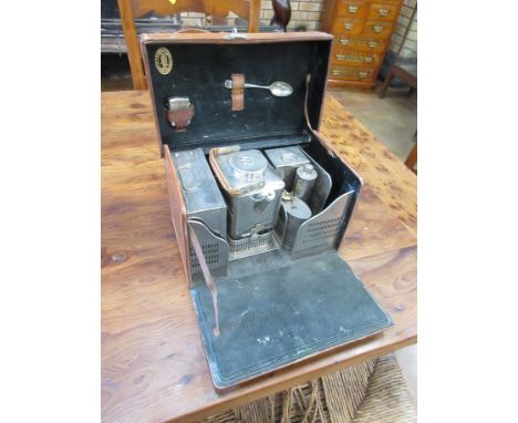 A leather cased Picnic Set containing white metal sandwich tin, stove and kettle, spirit flask, lighter and teaspoon, stamped