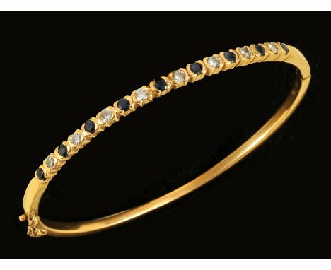 A Sapphire and Diamond hinged Bangle the front set alternating brilliant-cut stones, stamped 750