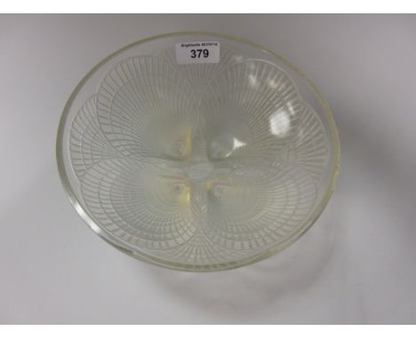 An R. Lalique circular Bowl in the coquille pattern, raised opalescent shelf, signed R Lalique and numbered 3202. 71/4 inches