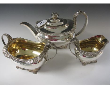 A George III silver three piece Tea Service of boat shape with gadroon and scallop border, anthemion and scroll feet, London 