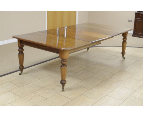 A Victorian mahogany Extending Dining Table with two spare leaves on turned tapering legs and casters, 4ft 3in x 8ft 2in