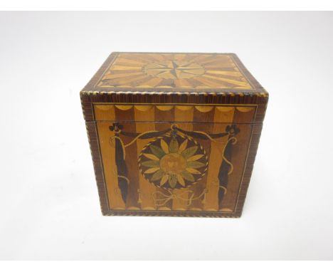 A Georgian mahogany and satinwood Tea Caddy, the lid with star and radiating design, the front with swag, bow and floral desi