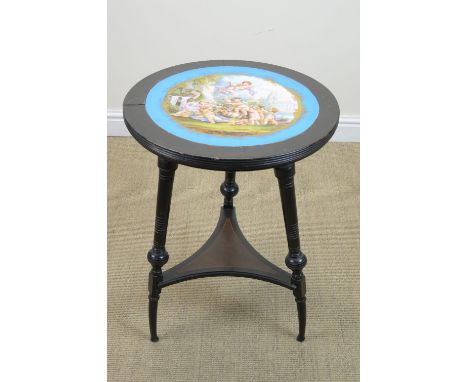 An Edwardian ebonised Occasional Table with porcelain inset top painted cherubs playing, 20in diam