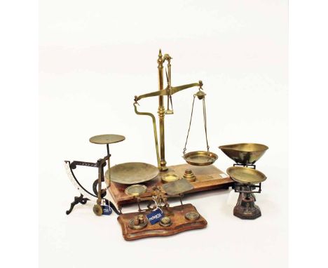 GROUP OF FOUR SETS OF SCALESto include beam scales with weights, 54cm high, 46.5cm long; brass postal scales with weights, 27