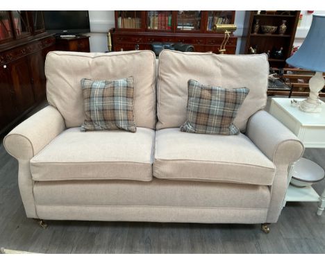 A modern beige two seater sofa with feather filled cushions, fire labels to cushions approx 167 long 