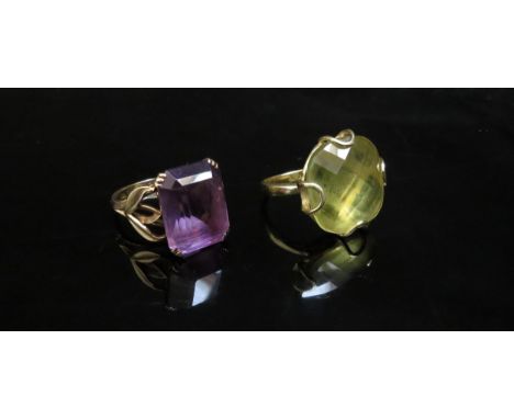 An 18ct gold ring with a large chequerboard cut yellow quartz, 2cm x 2cm. Size N, 10.2g and an amethyst ring stamped 9ct. Siz