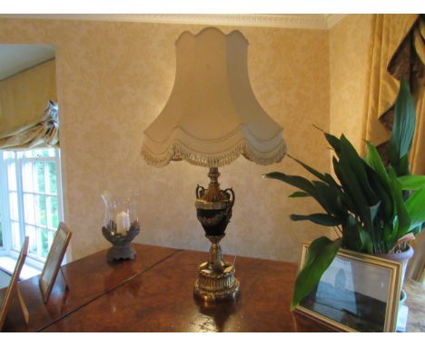 A Classical French style table lamp of urn form with swag and leaf detail, tasselled shade, approximately 103cm tall, Collect