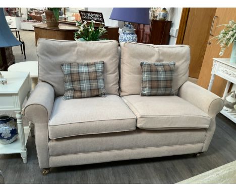 A modern beige two seater sofa with feather filled cushion, fire labels to cushions approx 167 long 