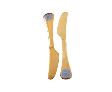 TWO GEORGE JENSEN SILVER GILT AND ENAMEL YEAR KNIVES FOR 1980, bears marks, each terminal with stylised flowerhead to one sid