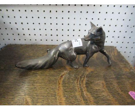 A silver coloured model, of a fox