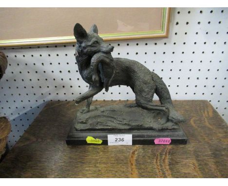 A model of a fox with a dead duck in its mouth