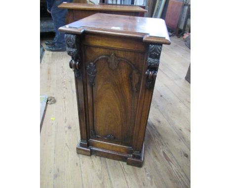 A 19th century rosewood bedside cabinet, the door with carved decoration opening to reveal a shelf, 16ins x 16.5ins, height 3