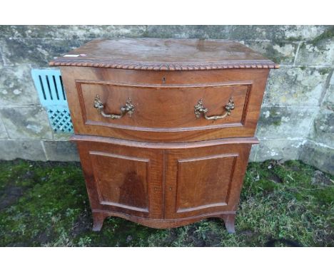 A 19th century serpentine fronted commode chest, with lift up top and gadrooned band, raised on splayed bracket feet,&nbsp; w
