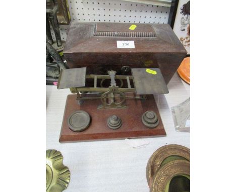 A set of Mordan &amp; Co gilt metal scales, on mahogany plinth with weights, together with a tea caddy