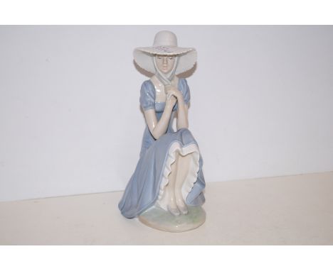 Nao figure of a seated lady - 28cm high