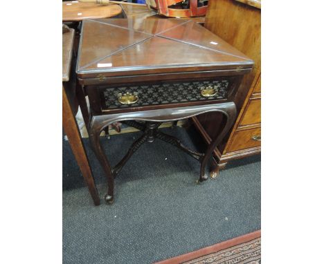 A late Victorian dark mahogany envelope card table in the Chippendale revival style having flap top, drawer and cross fret fr