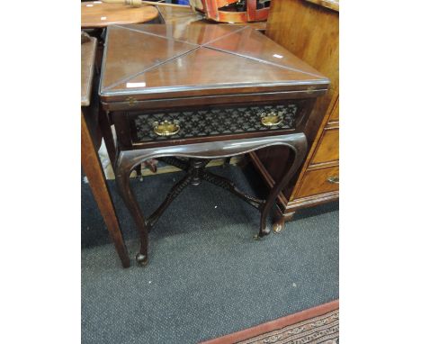 A late Victorian dark mahogany envelope card table in the Chippendale revival style having flap top, drawer and cross fret fr