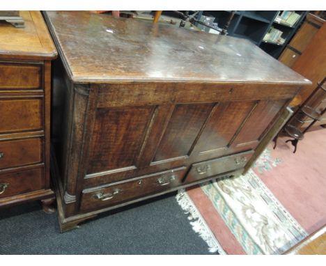 An 18th century and later oak mule chest having lift and panel top over drawer base and bracket feet