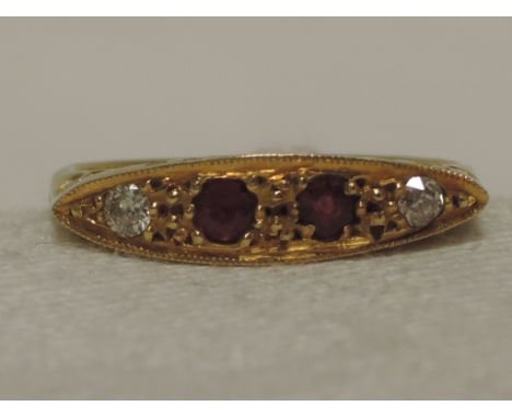 An Edwardian ladies dress ring having ruby and diamond decoration in a pave setting to pierced gallery mount on a yellow meta