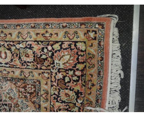 A late 20th century carpet square of Belgium design having floral pattern on salmon colour ground