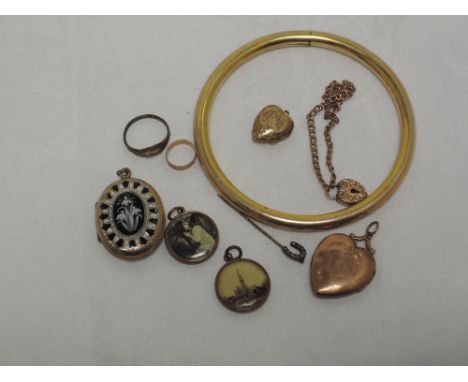 A selection of rolled gold jewellery including an upper arm bangle, bracelet, glass locket, mourning locket with enmelled sno
