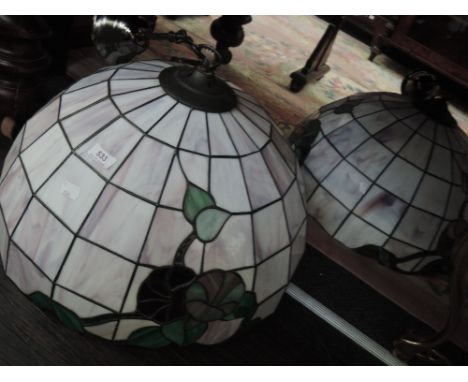 A pair of modern ceiling light shades in the Tiffany style