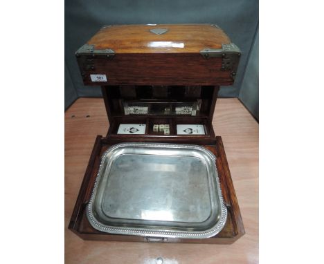 An Edwardian oak tantalus/games compendium having fully fitted interior with triple decanter section, glasses, cribbage board