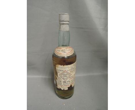 A bottle of 8 year old Malt Scotch whisky, approx 1924, Olde Iron Gate ? And Paine Tandii Market Street Bradford, level on sh