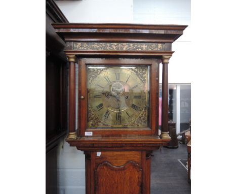A late 18th century oak longcase clock having square fret pillar hood with brass dial and 30 hour with fake winding holes by 