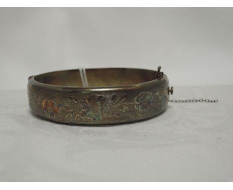 An HM silver hinged bangle having floral engraved decoration