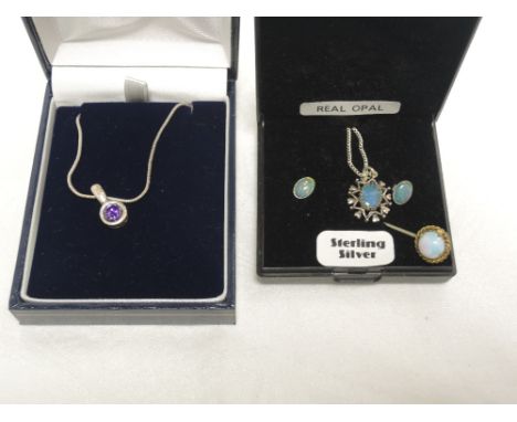 An opal pendant and matched stud earrings in white metal settings stamped silver/925, an opal pin. and an amethyst style pend