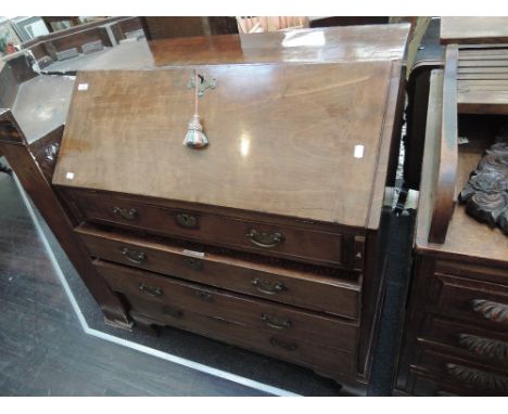 An early 19th century mahogany bureau having fall front with fitted interior over cockbeaded drawer base and bracket feet