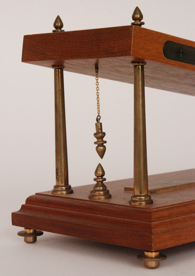 A late 20th Century barrel shaped gravity incline clock in the manner