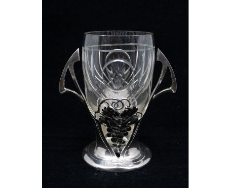 WMF: An Art Nouveau pewter two handled vase with cut glass liner, with grape and vine design and Jugendstil stylised handles.