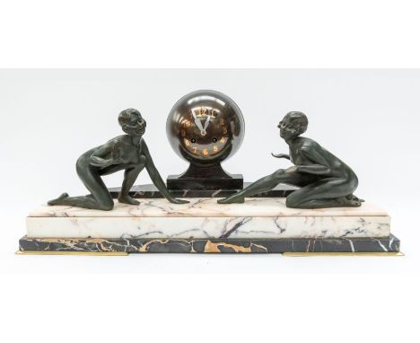 A large 1930's Art Deco mantle clock with globe face and lady detail to either side