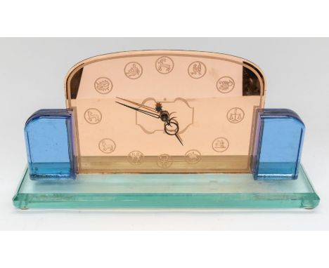 A large Art Deco glass style mantle clock with star sign numerals