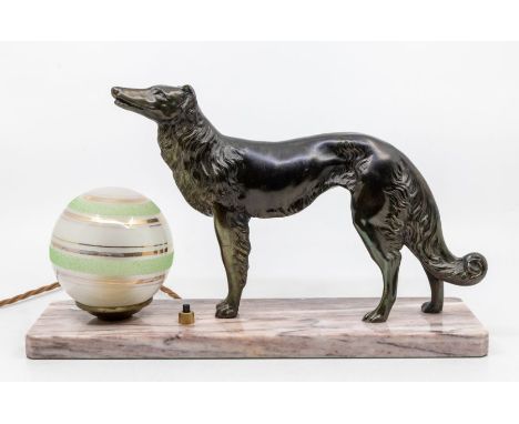 An Art Deco table lamp modelled as a spelter figure of a hunting dog next to globe shaped shade, all on marble base.Approx. 2