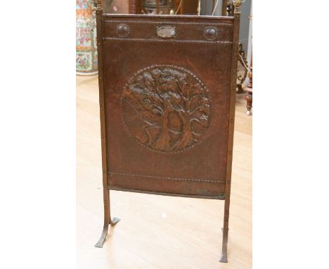 An Arts and Crafts hand made copper fire screen with brass columns and feet to each side, and with brass finials to tops. The