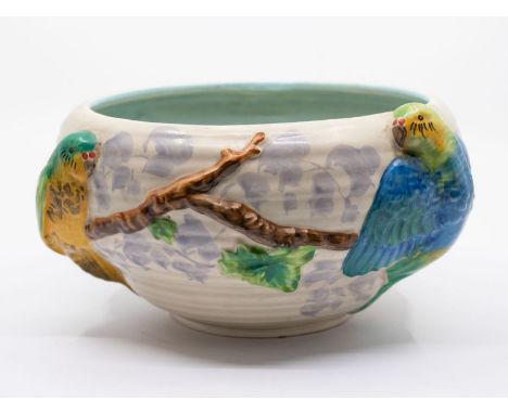Clarice Cliff - A mushroom glazed ground bowl with applied Parrot and branch design. Printed marks to base, Newport Pottery, 