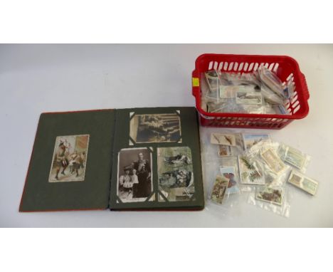 Vintage postcard album with contents and collection of cigarette and tea cards