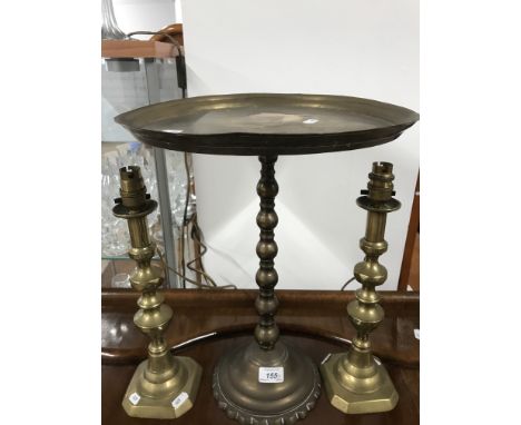 BRASS WINE TABLE AND A PAIR OF BRASS CANDLE STICKS WITH ELECTRIC CABLE FITTINGS