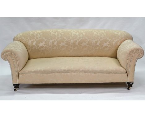 A traditional scroll arm Chesterfield sofa, raised on turned front legs to castors, 205 cm w x 90 cm deep x 82 cm h overall&n