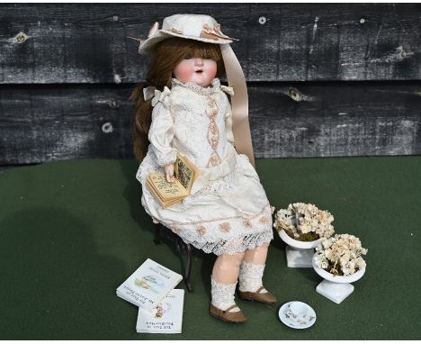 A vintage German bisque-headed girl doll by Simon &amp; Helbieg, SPBH 1909-Oz with closing blue eyes and open mouth, cropped 