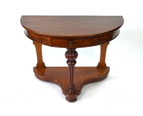 A mahogany demi-lune console table with frieze drawer, gadrooned and fluted front support and shaped platform base, 102 cm wi