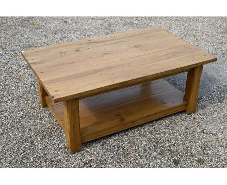 A modern light oak rectangular coffee table on chamfered square supports united by the open undertier, 120 cm x 74 cm x 47 cm