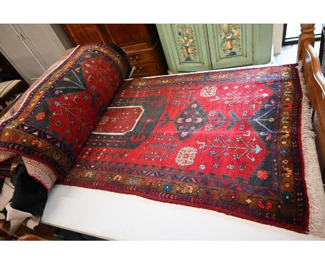 An Azari runner, the stylised floral design on a red ground with brown rosette border, 310 x 125cm&nbsp;