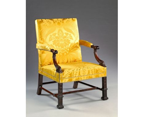 A 19th Century George III Style Carved Mahogany Library Armchair  The scrolling arm supports headed by acanthus scroll termin