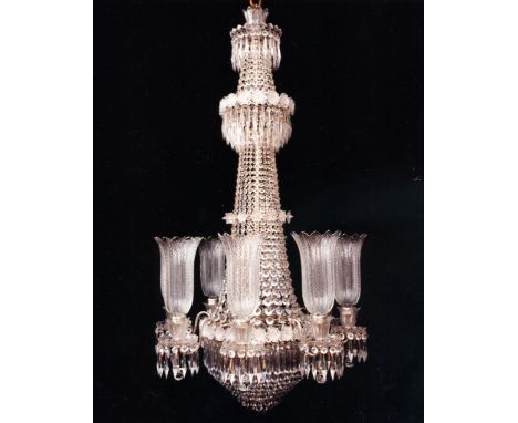 An Eight Light Regency Cut Glass and Lacquered Brass Chandelier  with elaborate and unusual cross cut rosettes on three tiers