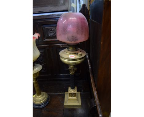 An antique brass oil lamp, with Corinthian capital to the black column. Condition Report: There is a dent in the brass font. 