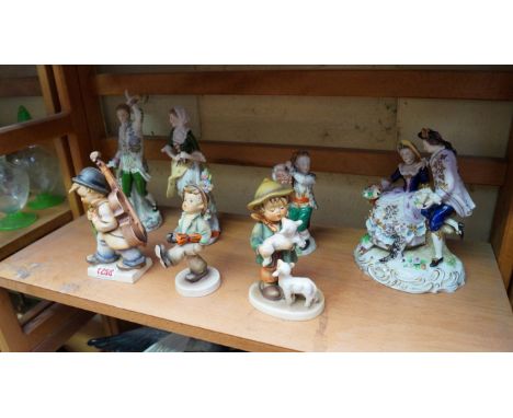 Three Goebel figures; together with a pair of Sitzendorf figures; another Sitzendorf figure group; and one other Sitzendorf f